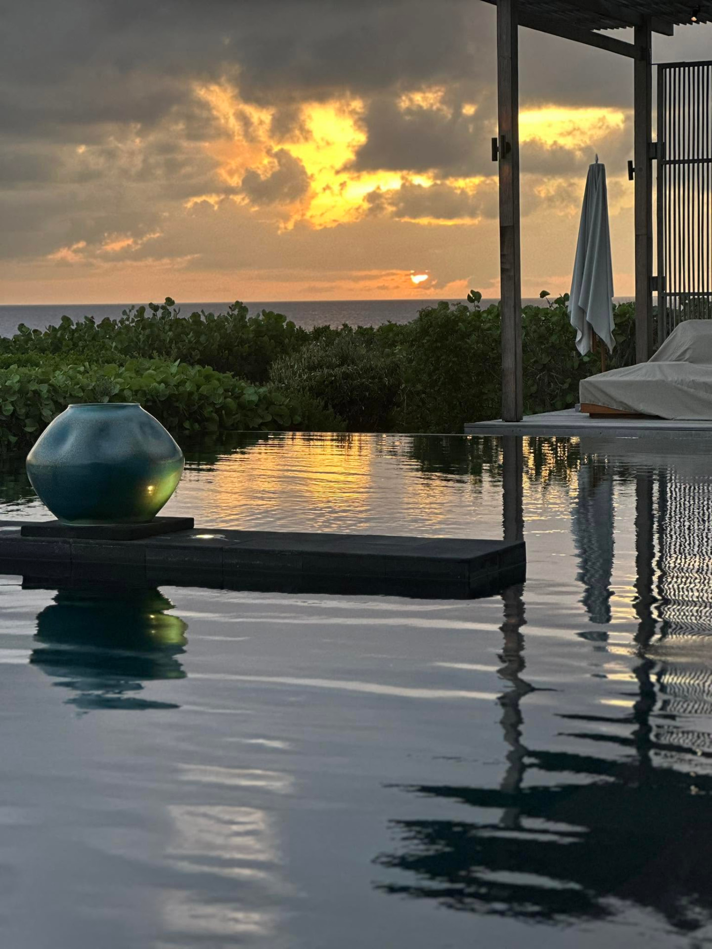Sunset over an infinity pool at a luxury sound healing retreat