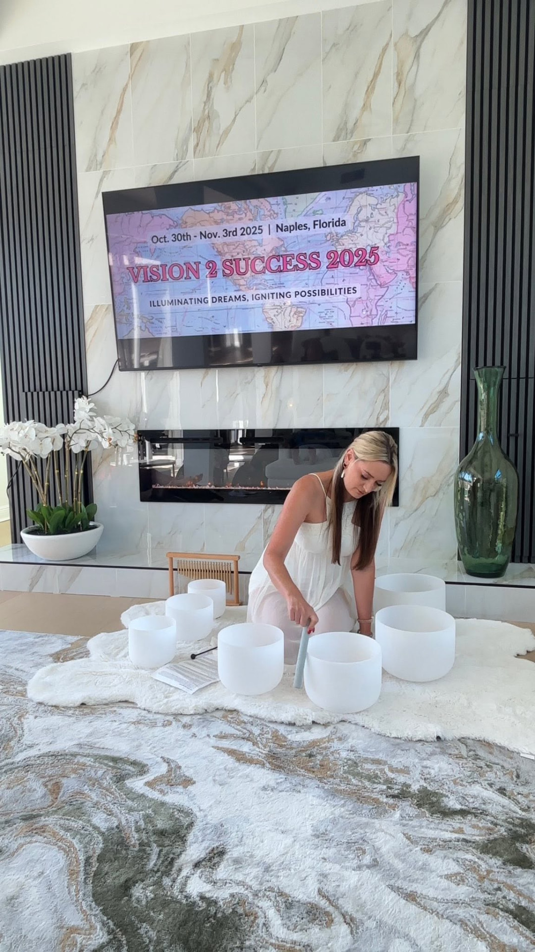 Michelle playing crystal singing bowls with a mallet during a retreat sound bath
